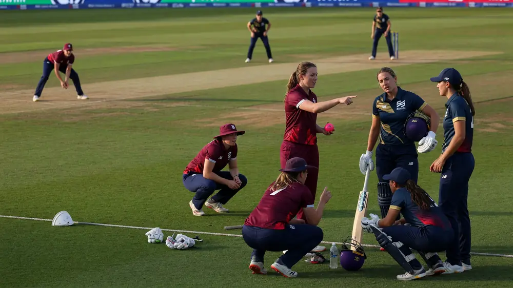 Medium tactical view of fielders set for a white-ball delivery with the bowler at the top of the mark on a green outfield